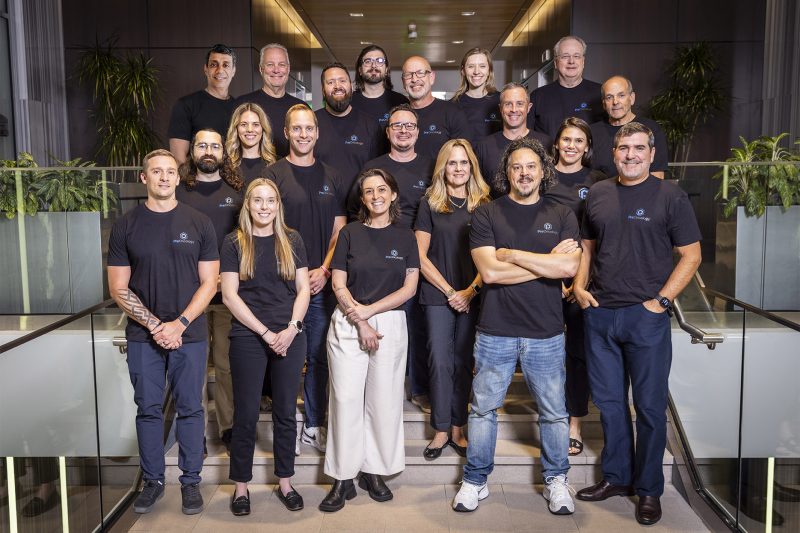 A group of PreOncology employees standing and looking at the camera, smiling.